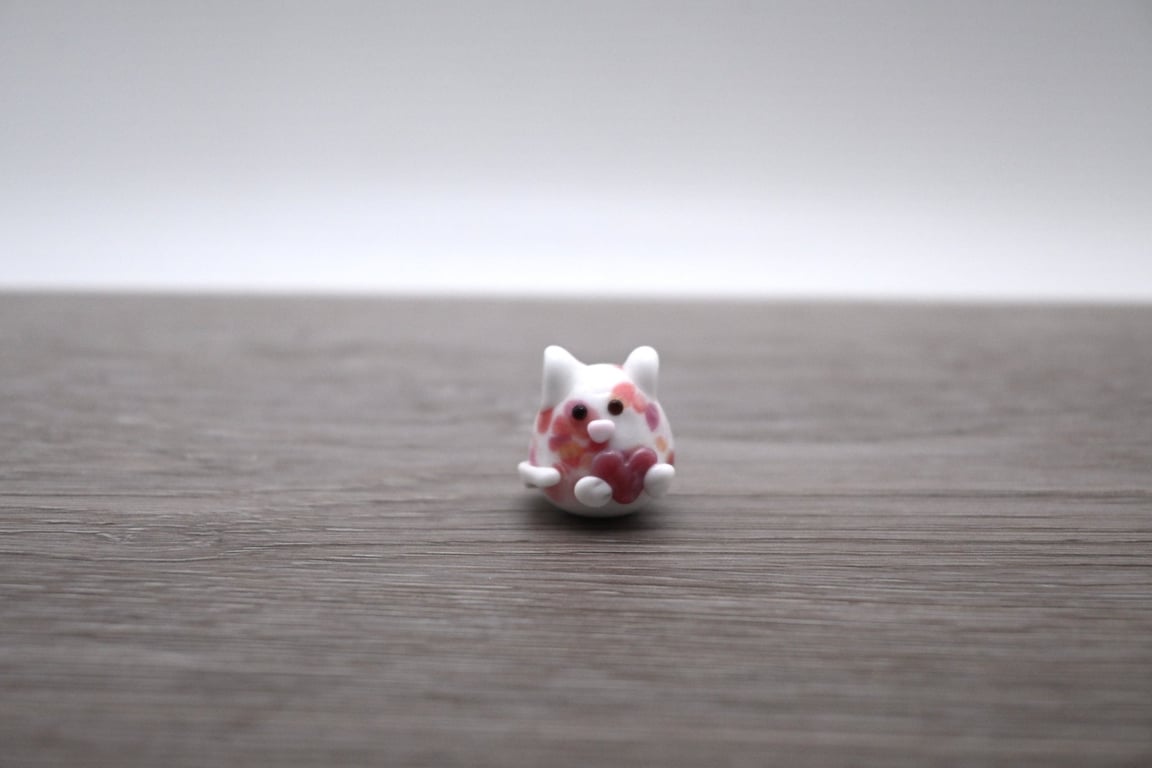 small glass cat figure with heart