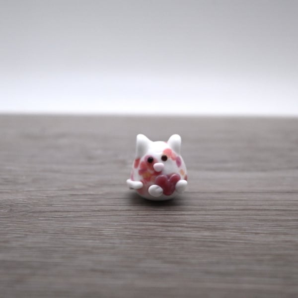 small glass cat figure with heart