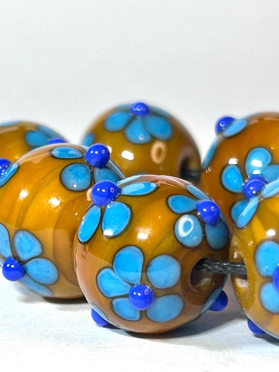 Handmade blue and yellow daisy patterned lamp work glass beads