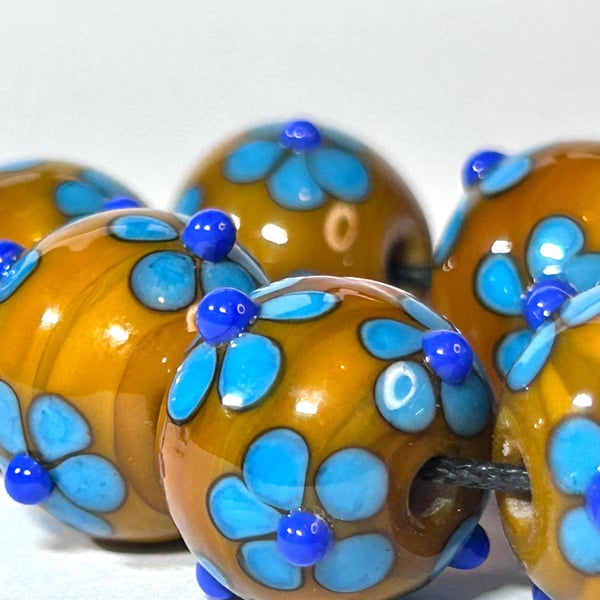 Handmade blue and yellow daisy patterned lamp work glass beads