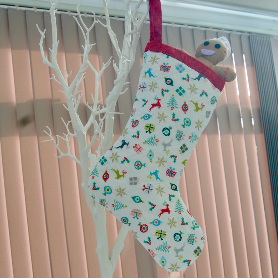 Hanging Christmas Stocking with scattered Christmas motifs.