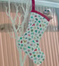 Hanging Christmas Stocking with scattered Christmas motifs. - Image 1