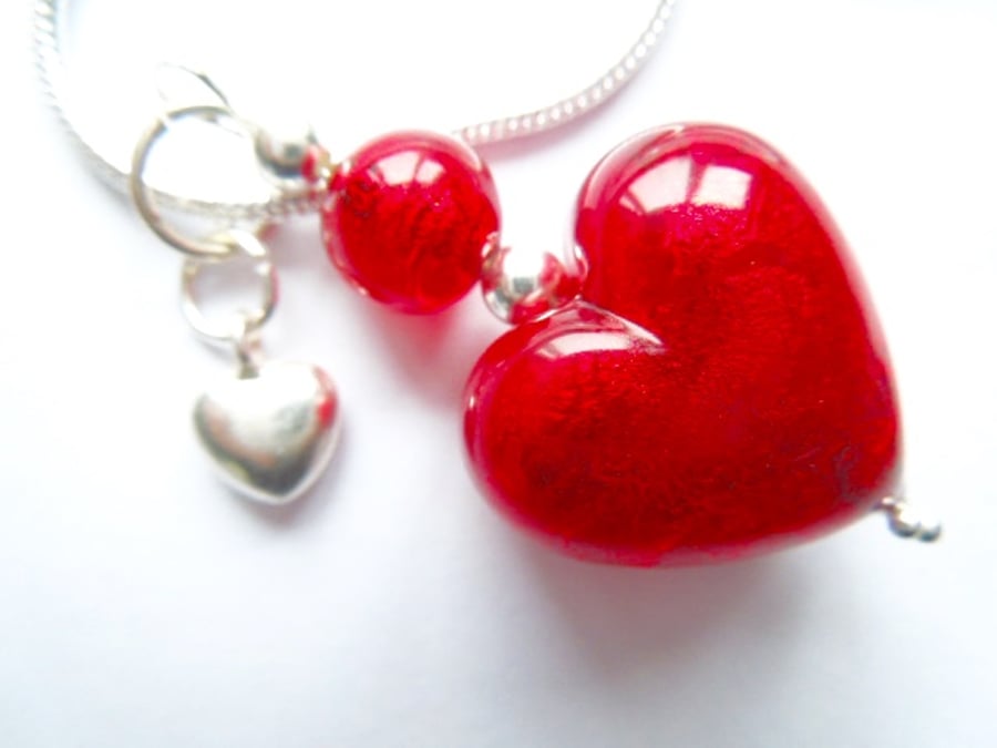 Murano glass red heart pendant with sterling silver charm and chain.