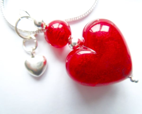 Murano glass red heart pendant with sterling silver charm and chain.
