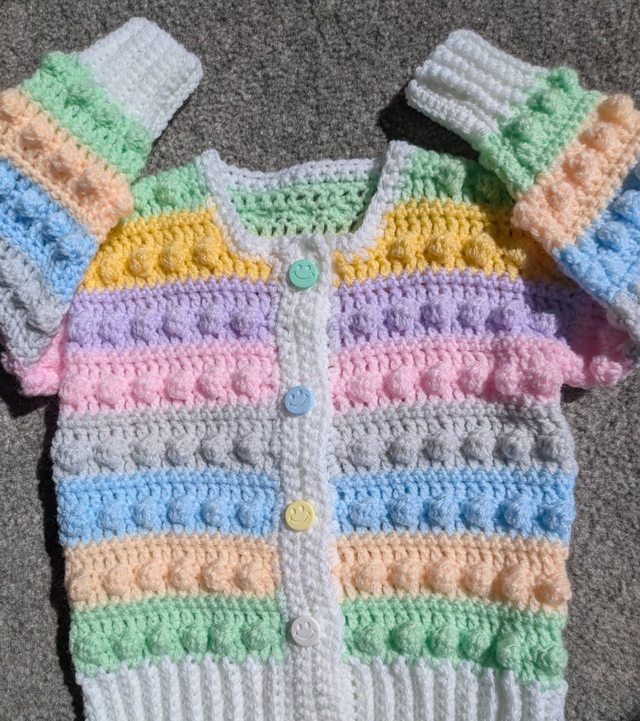 Multi coloured pastel cardigan for one year old with smiley buttons 