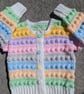 Multi coloured pastel cardigan for one year old with smiley buttons 