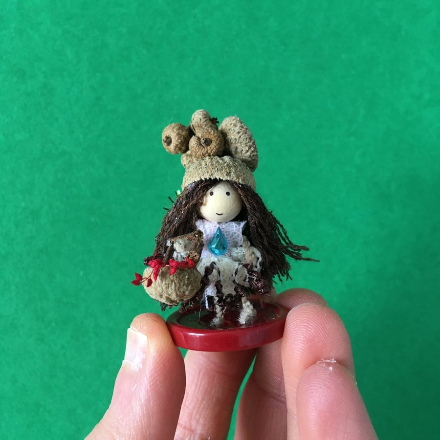 Tiny Button Fairy With A Basket And An Acorn Cup Hat