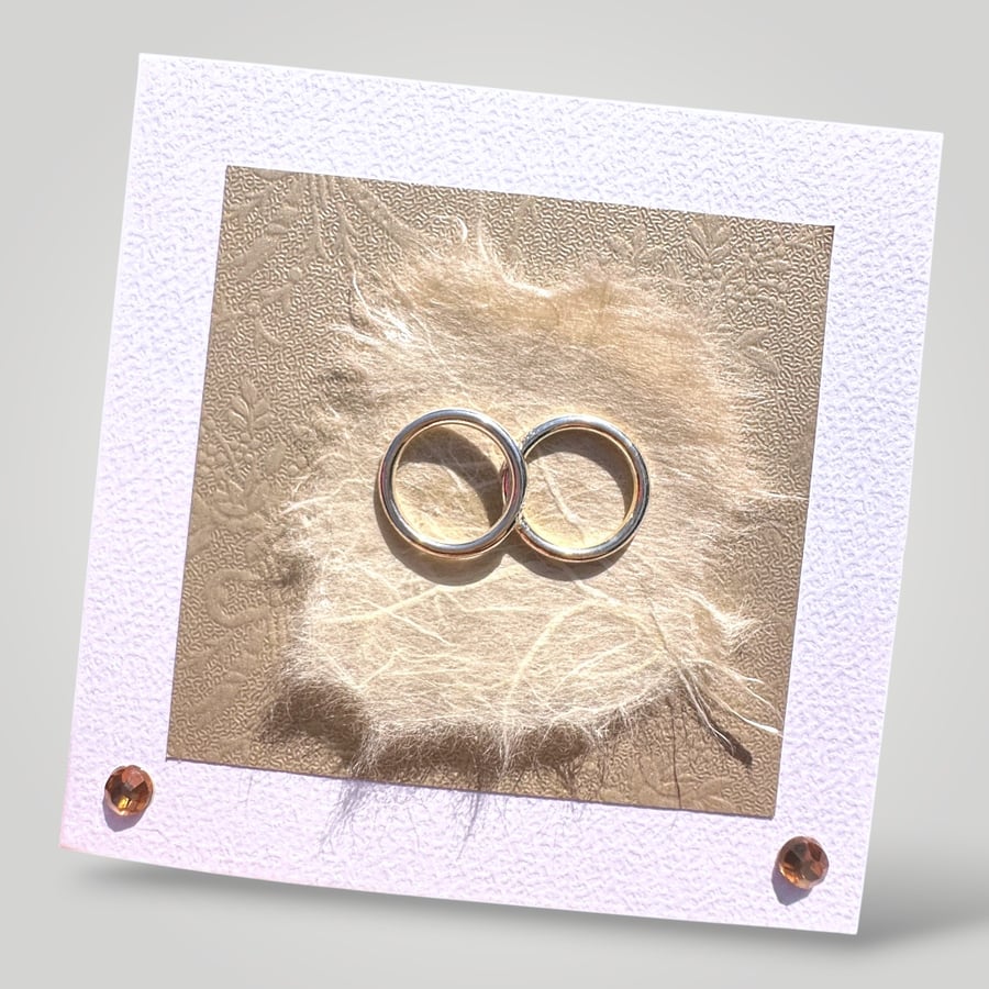 Handmade Wedding Card, entwined Gold rings with embossed and handmade papers. 