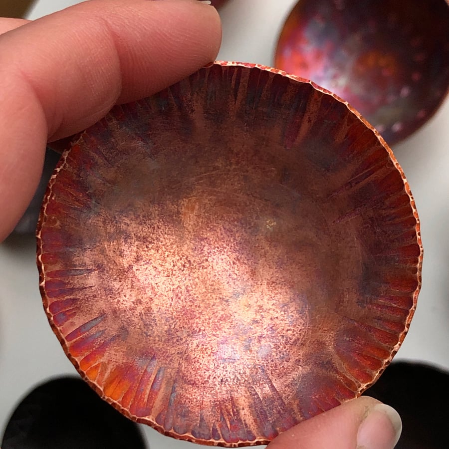 Flame painted copper bowl with hammered detail.