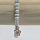 Pearl blue seed bead bracelet with small white flower charm
