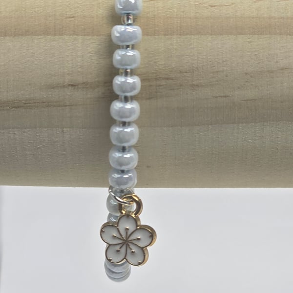Pearl blue seed bead bracelet with small white flower charm