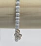 Pearl blue seed bead bracelet with small white flower charm - Image 1