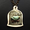 Blue bird in a cage ceramic pendant