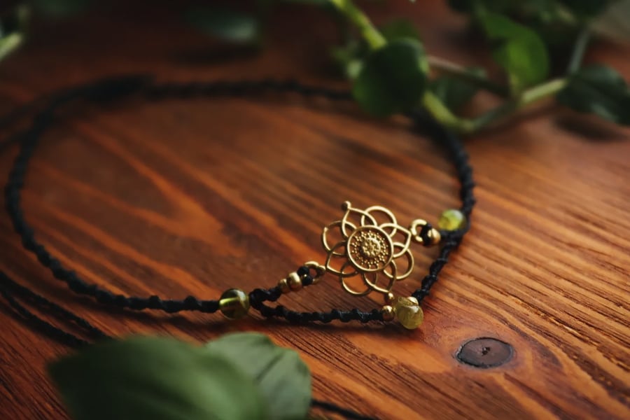 Adjustable black choker with peridot and flower brass charm 