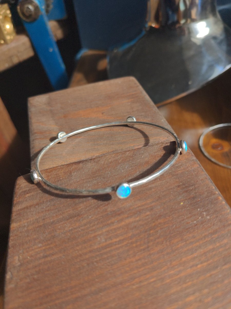 Recycled sterling silver bangle, with multiple blue synthetic opals.