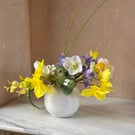Daffodil, Hellebores and Iris in white round vase
