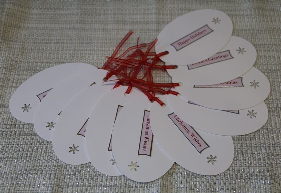 10 Oval Christmas Gift tags, snowflake aperture & coloured printed greeting