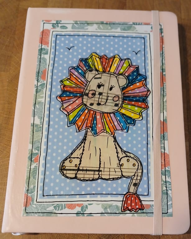 Quirky art A5 lined hardbacked notebook, hand decorated whimsical rainbow lion.