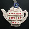 Ceramic teapot decoration with button flower