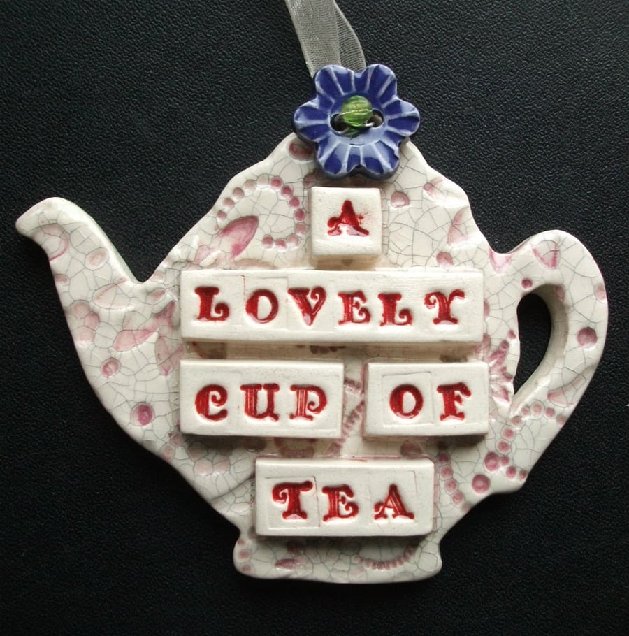Ceramic teapot decoration with button flower