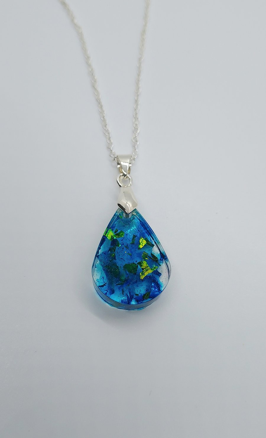 Blue resin teardrop pendant necklace on an 18" silverplated chain