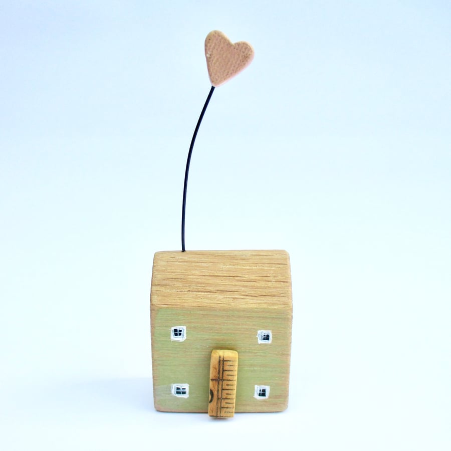 Little wooden house with a clay heart