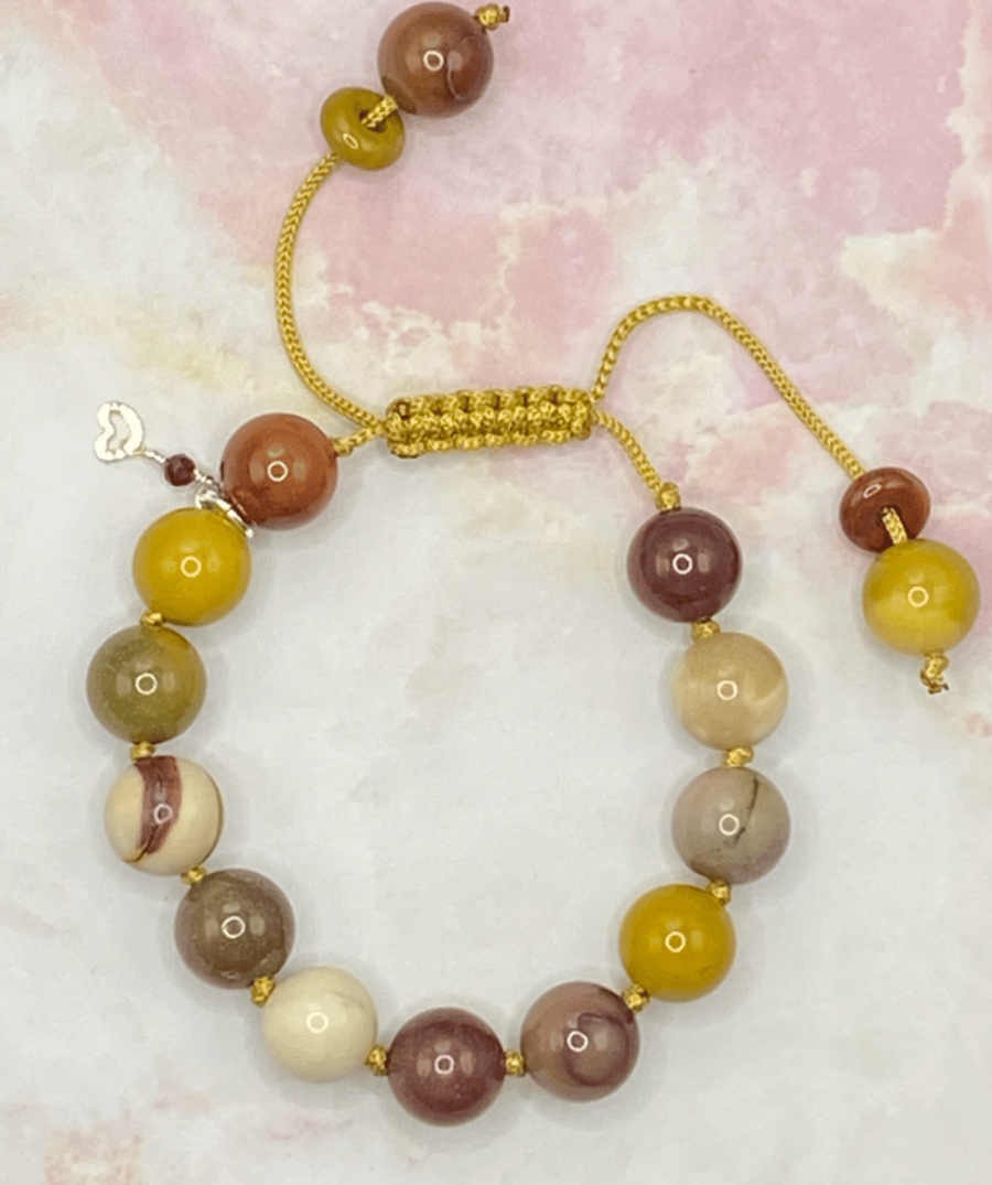 Knotted gold cord bracelet with mookaite stones and silver plated charm