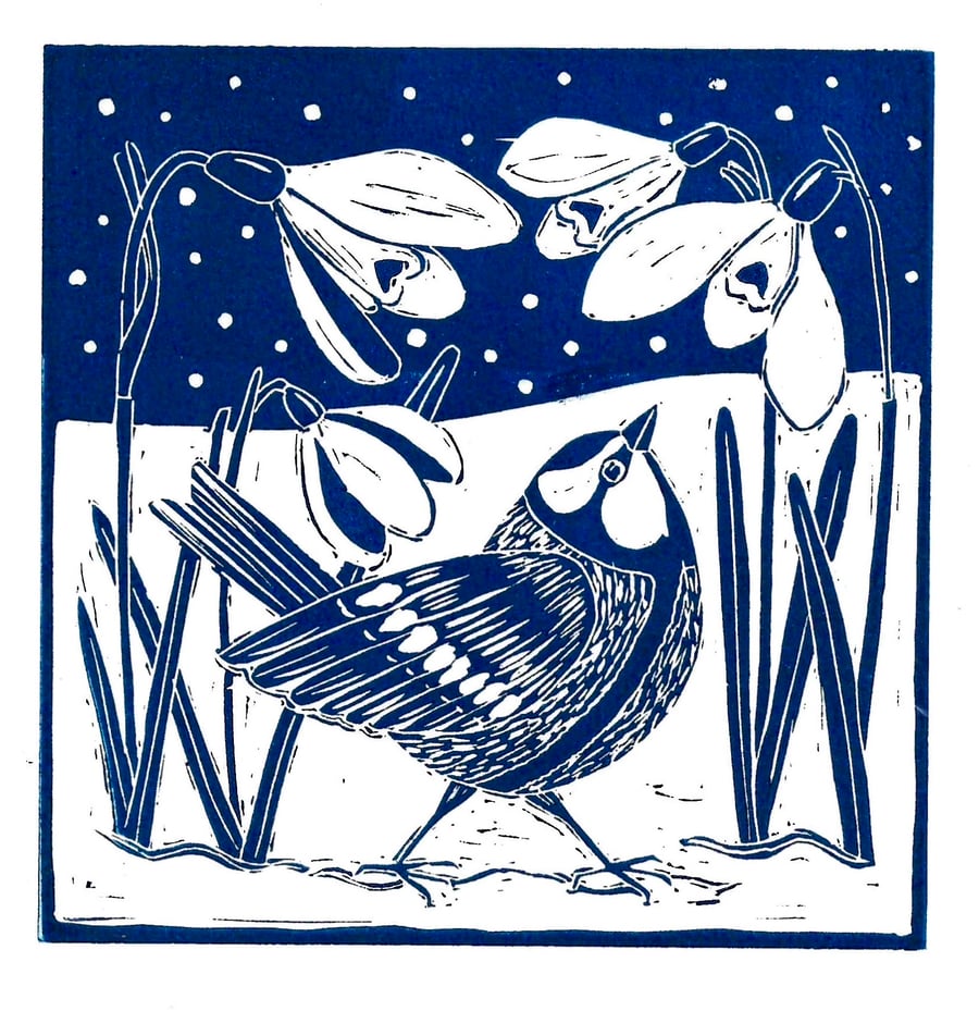 A freshly printed linocut card featuring snowdrops and a Great Tit