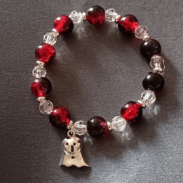 Elasticated red, black and clear beaded bracelet with silver ghost charm
