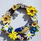  Crocheted spring flowers and a blue tit adorn a 25cm rattan wreath base.