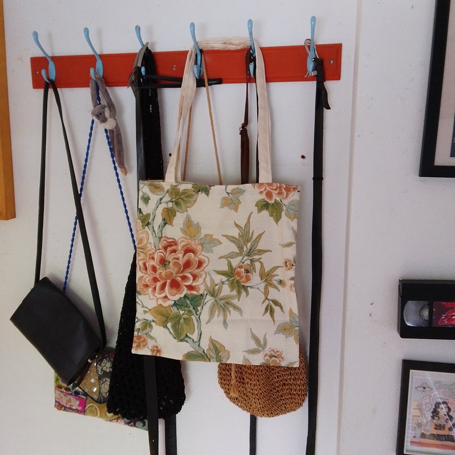 tote bag made of cream fabric with orange flower pattern