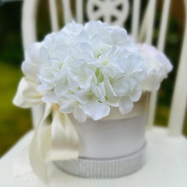 Luxury artificial flower arrangement in a hatbox with hydrangeas