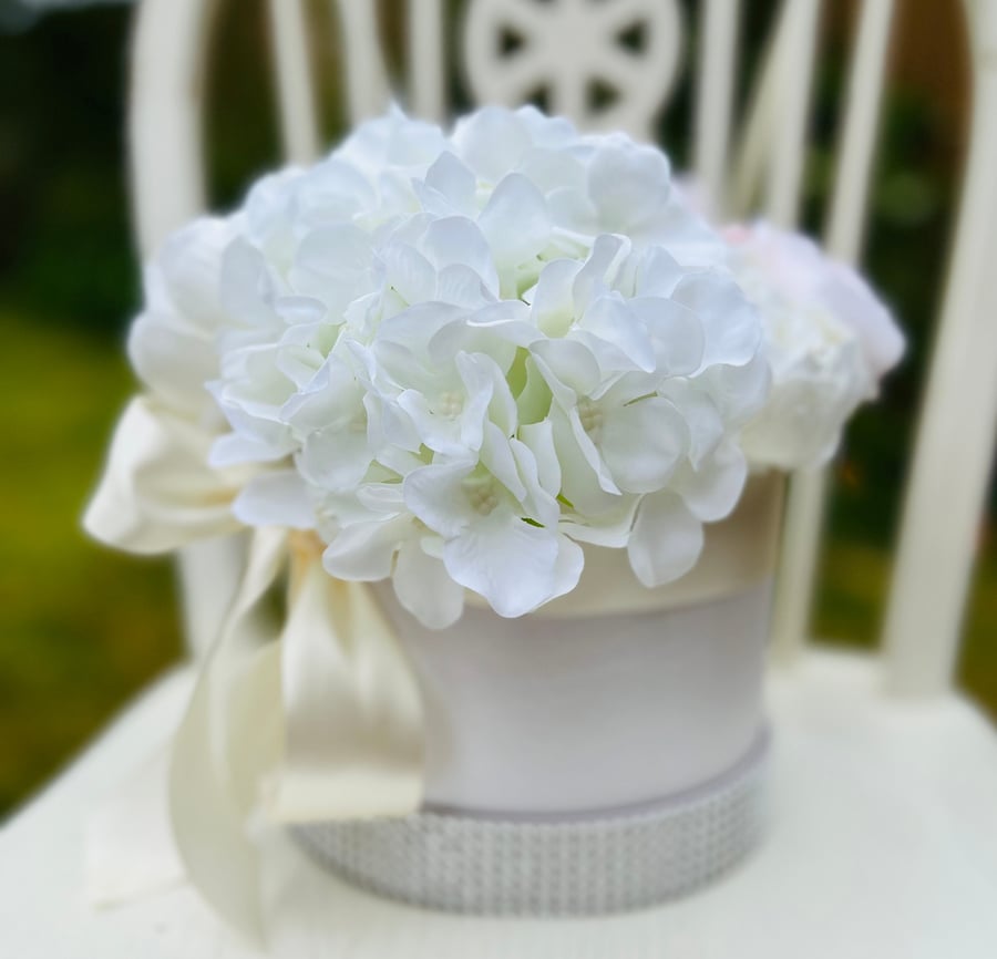 Luxury artificial flower arrangement in a hatbox with hydrangeas