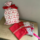 Reusable fabric gift bags.