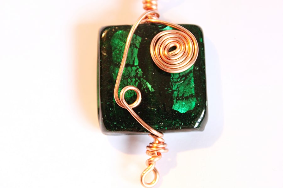 Deep green square glass foiled bead wrapped with spirals of copper wire 