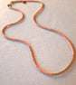 Glass beaded necklace, peach and gold, 20 to 22 inches