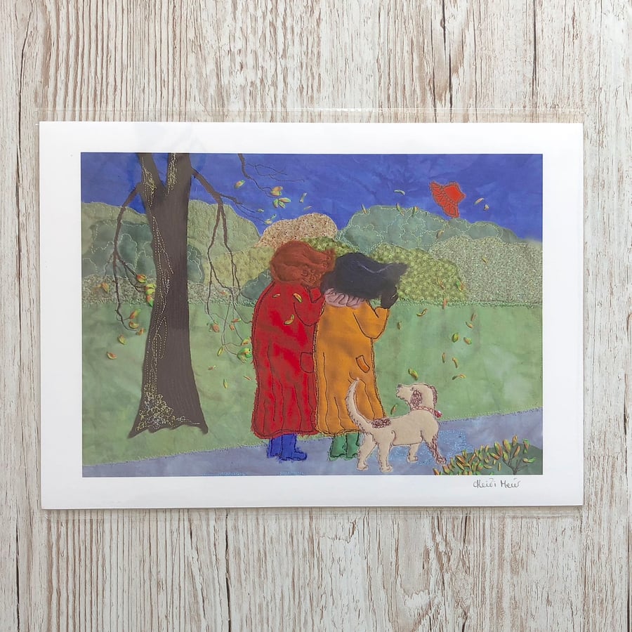 Fun autumn country scene of two ladies and dog with hat blowing away in the wind