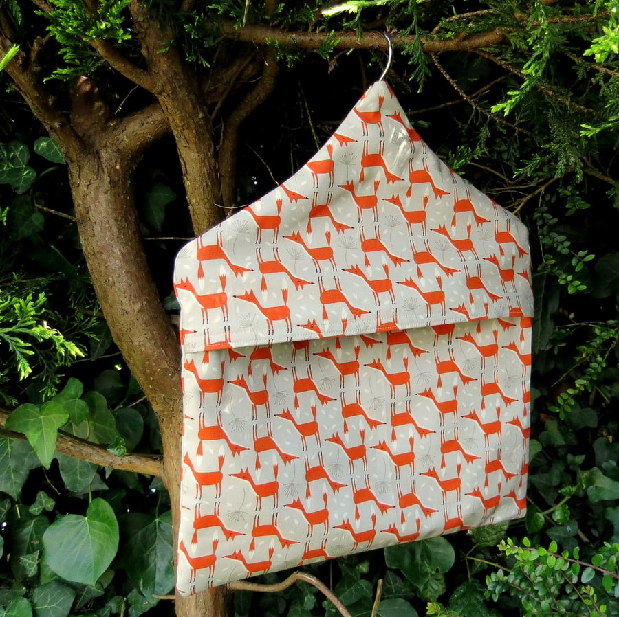 A peg bag with a foxes design.  Peg storage.