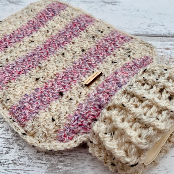 A hot water bottle and handmade crochet cover in tweed pink and purple