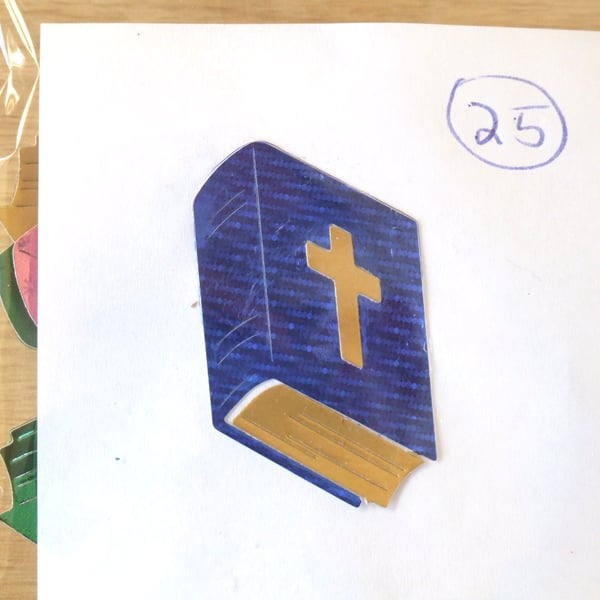 25 Sizzix die cuts of the Holy Bible in various colours.
