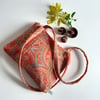 Handbag or shoulder bag in a tapestry effect fabric with chunky zip closure.