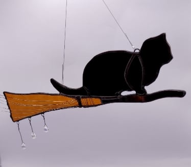 Hand made stained glass, cat on a broomstick 
