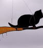 Hand made stained glass, cat on a broomstick 