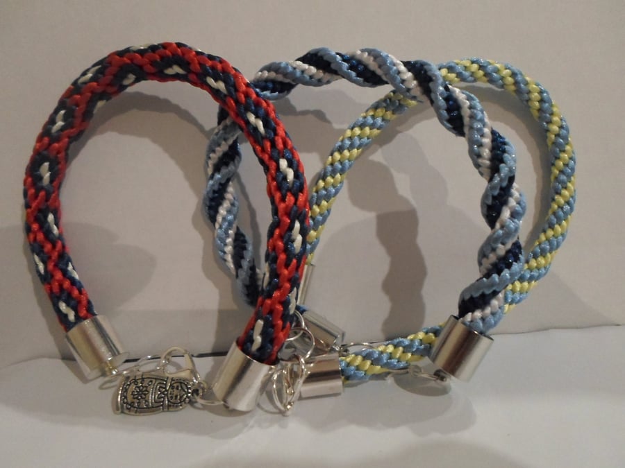 3 X KUMIHUMU BRACELETS IN BLUES AND WHITE AND RED, WHITE AND BLUE