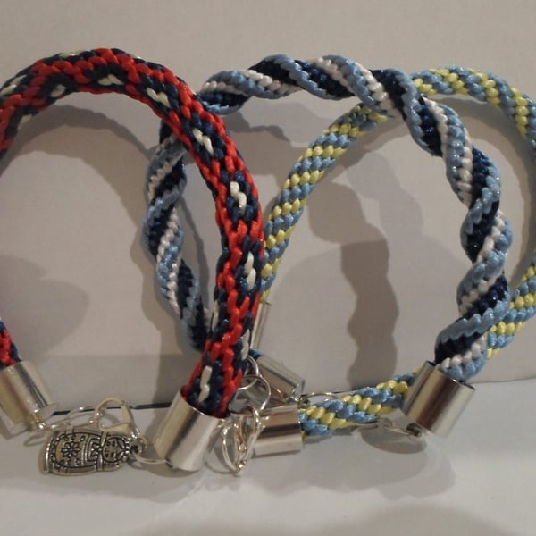 3 X KUMIHUMU BRACELETS IN BLUES AND WHITE AND RED, WHITE AND BLUE
