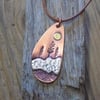 Copper and silver 'winter sun' mixed metals scene pendant