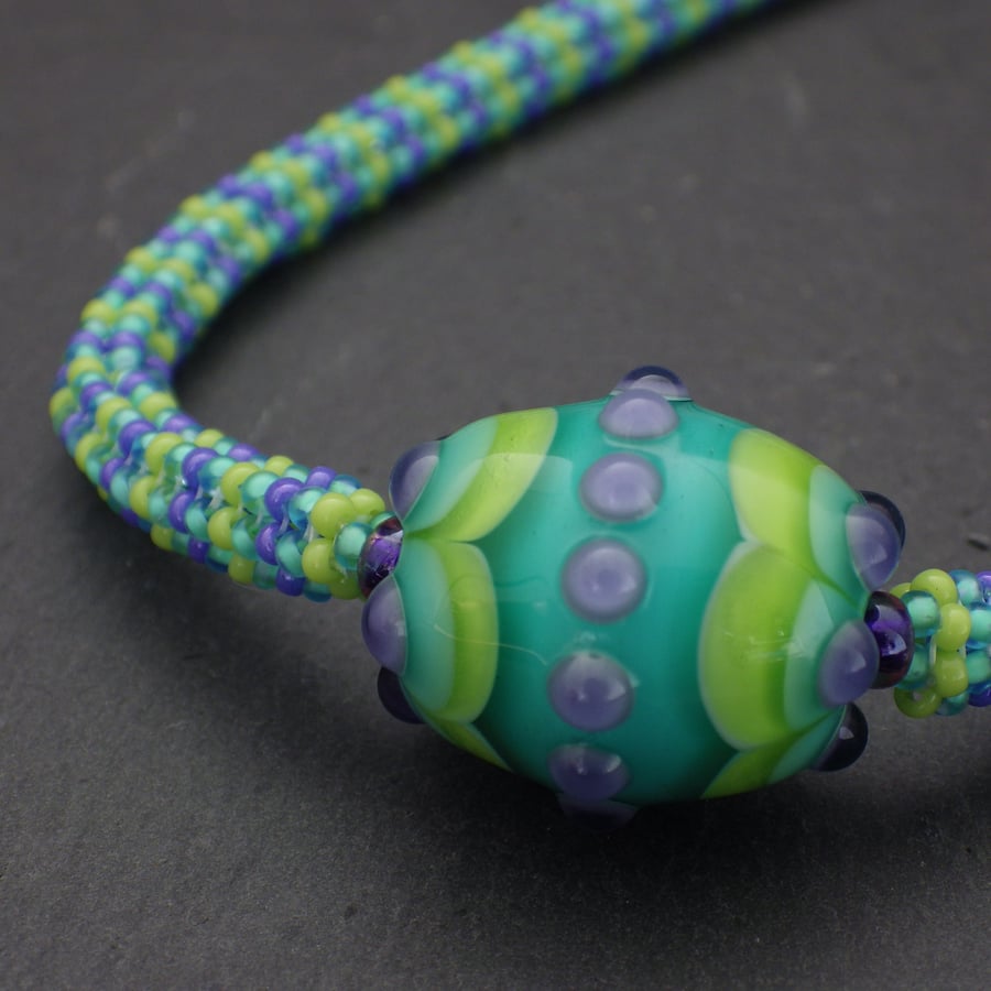 Green, turquoise and purple beadwoven necklace with pretty UK lampwork bead