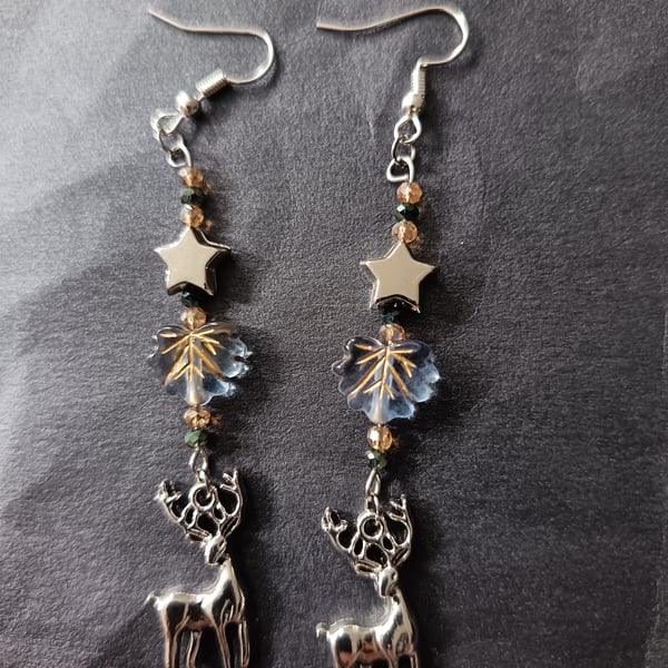Wintry beaded star and leaf dangle earrings with silver stag charm 