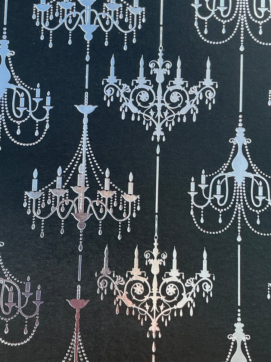 Four sheets of black card with silver and gold printed chandeliers