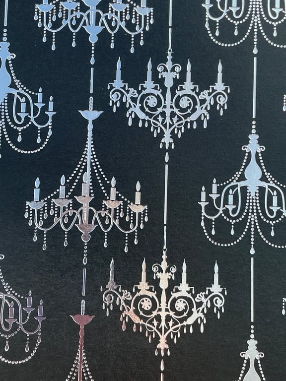 Four sheets of black card with silver and gold printed chandeliers